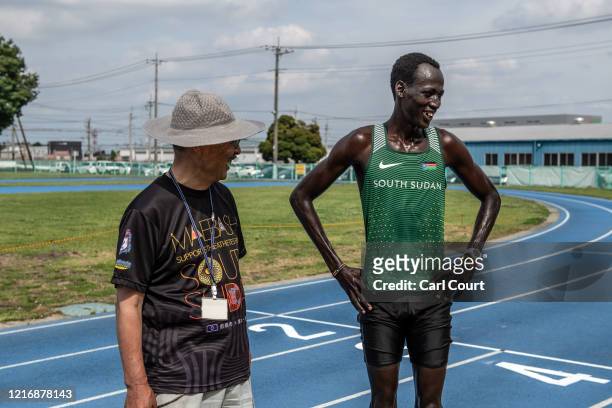 Year-old South Sudanese 1500m runner Abraham Majok Matet Guem chats with translator Fumio Matsumura as he trains at an athletics track on June 2,...