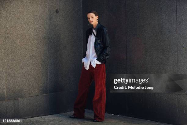 Model Sara Blomqvist wears milanova studios hoop earrings, a black leather jacket, white blouse, brown corduroy trousers, and black boots after the...