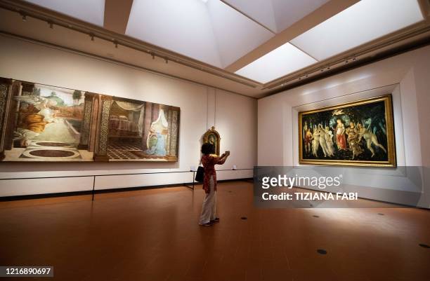 Journalist takes a photo of Sandro Botticelli's "Primavera" at the Uffizi Gallery Museum in Florence on June 2 during a press preview on the eve of...