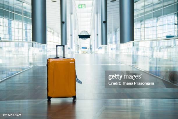 suitcase or baggage with airport luggage trolley in the international airport - koffer stockfoto's en -beelden