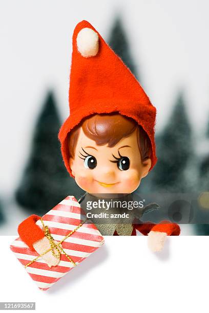 small ornamental christmas elf wearing red hat - elf stock pictures, royalty-free photos & images