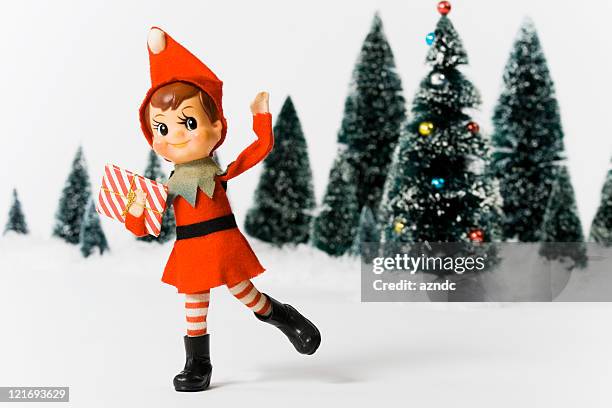 vintage christmas doll in front of christmas trees - nimf stockfoto's en -beelden