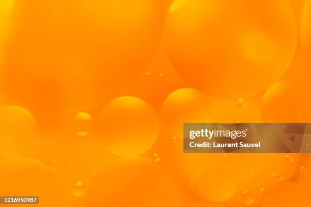 oil and water orange bubbles and drops - orange colour background stock pictures, royalty-free photos & images