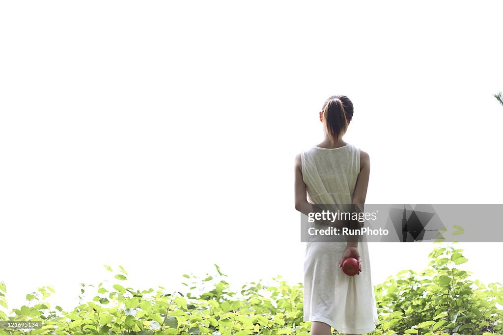 Workout  woman is holding an apple