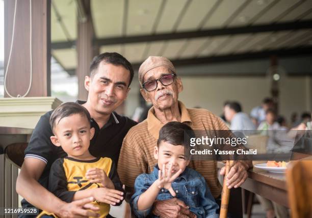 disability senior man with son and grandson - indonesiskt ursprung bildbanksfoton och bilder