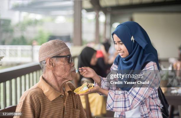 grandfather and granddaughter - ramadan indonesia stock pictures, royalty-free photos & images