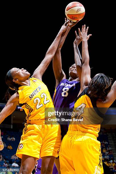 Delisha Milton-Jones of the Los Angeles Sparks fires a shot over the guard of Sheryl Swoopes and Amber Holt of the Tulsa Shock during the WNBA game...