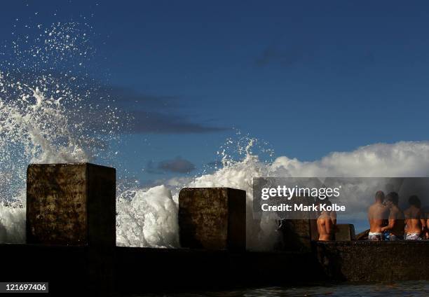 Swans players walk in the ocean baths during a Sydney Swans AFL recovery session at Coogee Beach on August 22, 2011 in Sydney, Australia.