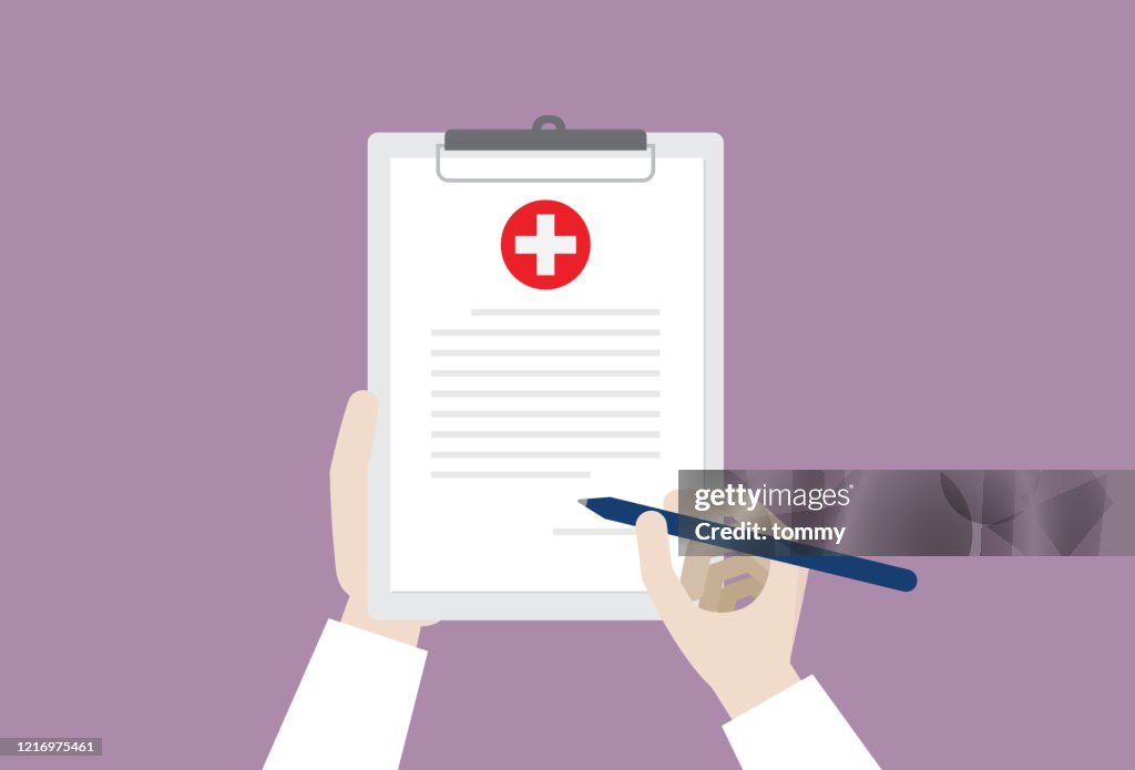Doctor signing a medical certificate