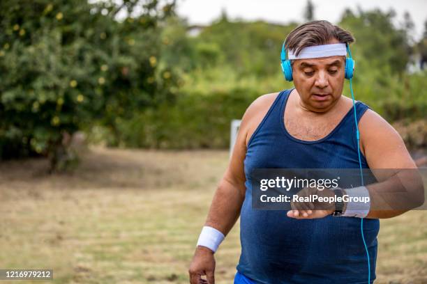 runner taking pulse - fat loss training stock pictures, royalty-free photos & images