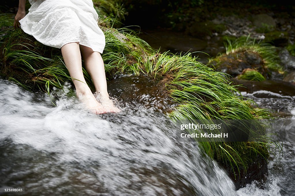 Woman who is soaked to beautiful river