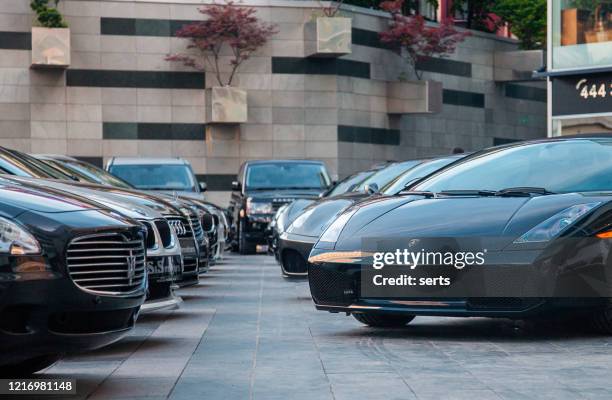 row of luxury sports cars - sports car showroom stock pictures, royalty-free photos & images