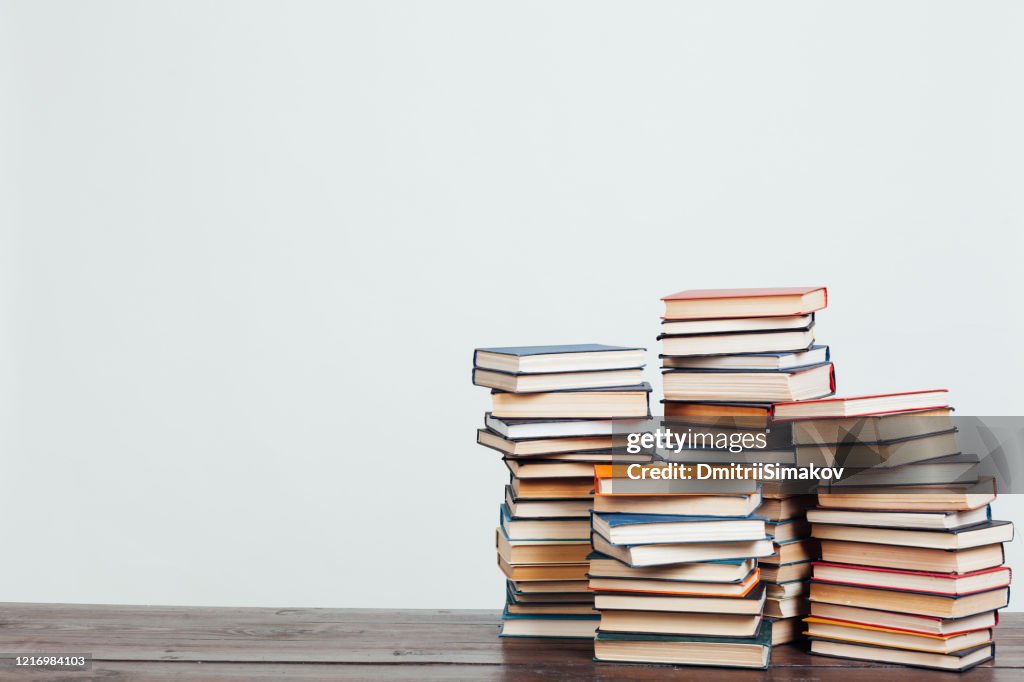 Many stacks of educational books at home preparing for exams on a white background