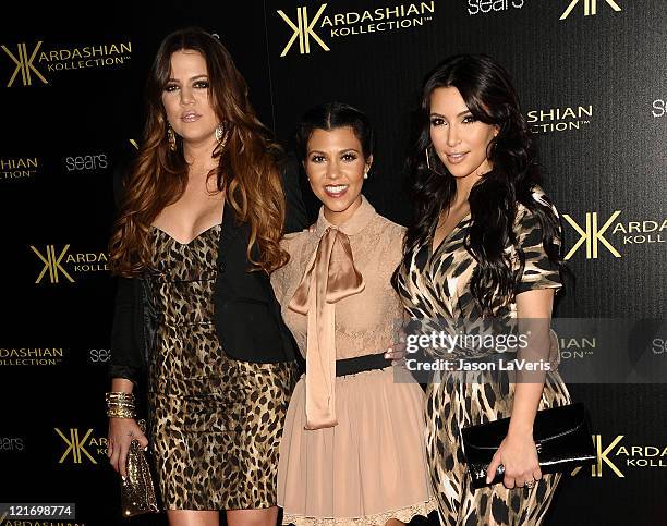 Khloe Kardashian, Kourtney Kardashian and Kim Kardashian attend the Kardashian Kollection launch party at The Colony on August 17, 2011 in Hollywood,...