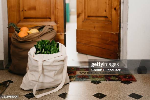 two bags of fruit and vegetables delivered near the home door - social distancing shopping stock pictures, royalty-free photos & images