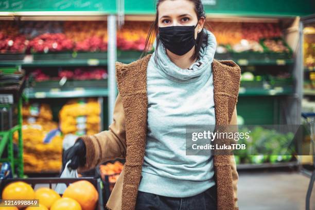 disinfecting groceries during covid-19 - store opening covid stock pictures, royalty-free photos & images