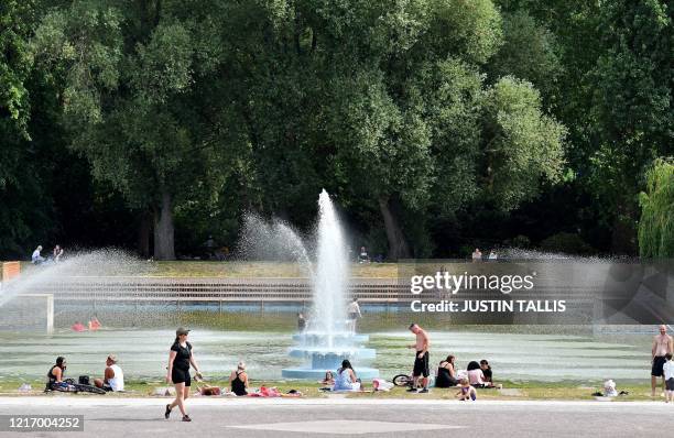 Woman enjoys the sunshine as she ssunbathes in Battersea Park, in London on June 2 as warm weather continues during the coronavirus lockdown. -...