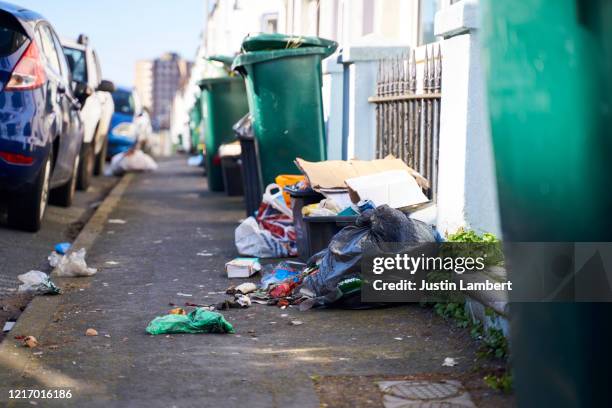 trash in the street spilling on to the pavement - slag heap stock pictures, royalty-free photos & images