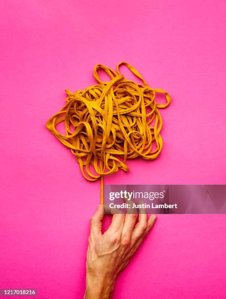 pulling thread from a messy ball of yarn - tangled yarn stock pictures, royalty-free photos & images