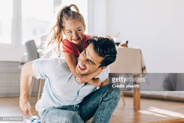 father playing with his little girl at home - family with one child stock pictures, royalty-free photos & images