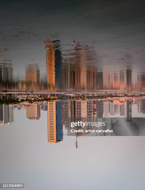 skyscraper refletion on the water - angola water stock pictures, royalty-free photos & images