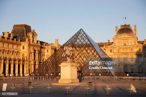 The Louvre Museum, the Louvre Pyramid and the “Cour Carree” at sunset is closed until further notice during the coronavirus epidemic on April 5 in...