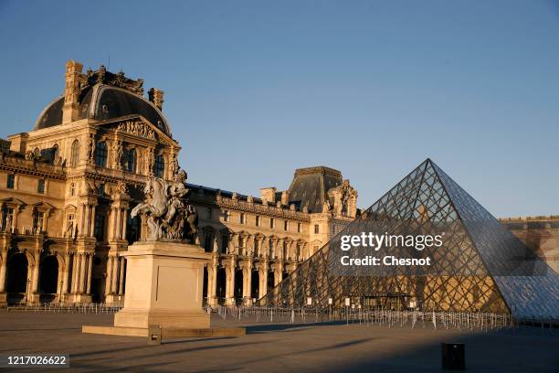 The Louvre Museum, the Louvre Pyramid and the “Cour Carree” at sunset is closed until further notice during the coronavirus epidemic on April 5 in...