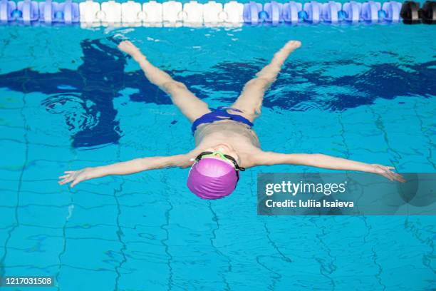 relaxed swimmer floating on back in pool - aqua star pool stock pictures, royalty-free photos & images