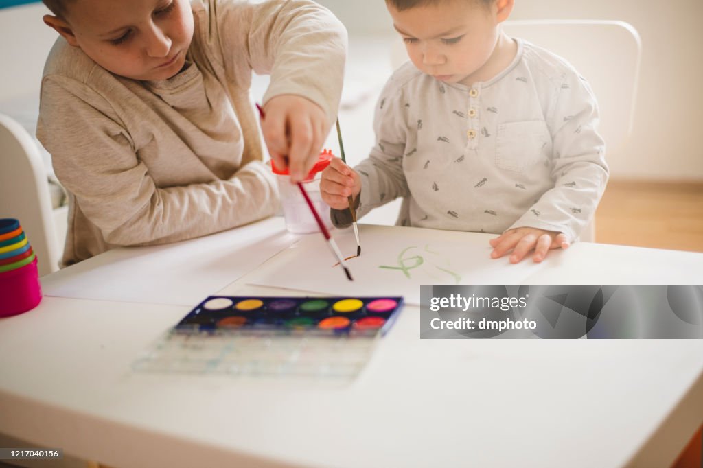 Boys painting with watercolors