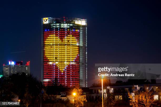 The DHL Post tower thanks all the Corona crisis workers with an illuminated heart of lights during the coronavirus crisis on March 05 in Bonn,...