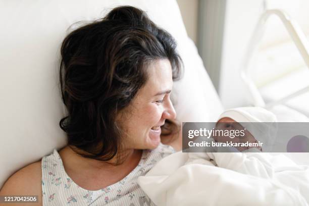 new born baby with his mother - baby delivery stock pictures, royalty-free photos & images