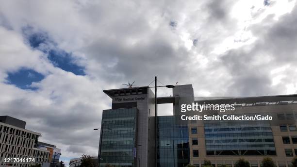 An emergency medical transport helicopter lands on a helipad atop the University of California San Francisco medical center during an outbreak of the...