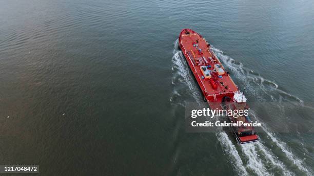 aerial view of a boat passing on the hudson river - barge stock pictures, royalty-free photos & images