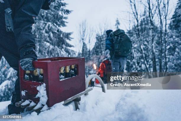 vrienden wandelen door sneeuw bij schemering - krat stockfoto's en -beelden