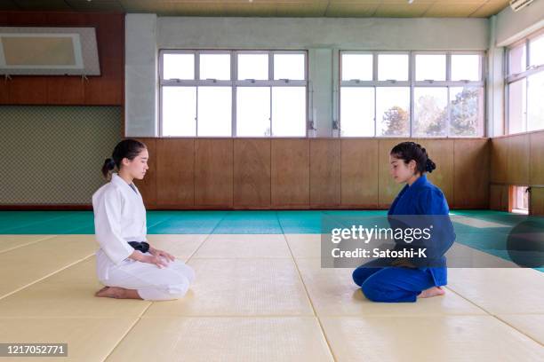 atletas de judo sentados sobre tacones antes del partido - women's judo fotografías e imágenes de stock