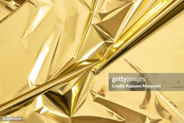 metallic gold mylar paper texture background - gift wrapping stock pictures, royalty-free photos & images