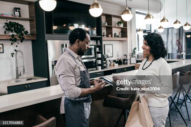 customer and owner having small talk - debit cards credit cards accepted stock pictures, royalty-free photos & images