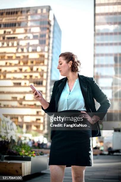 portrait of caucasian businesswoman using mobile app to book a taxi - ghosted stock pictures, royalty-free photos & images