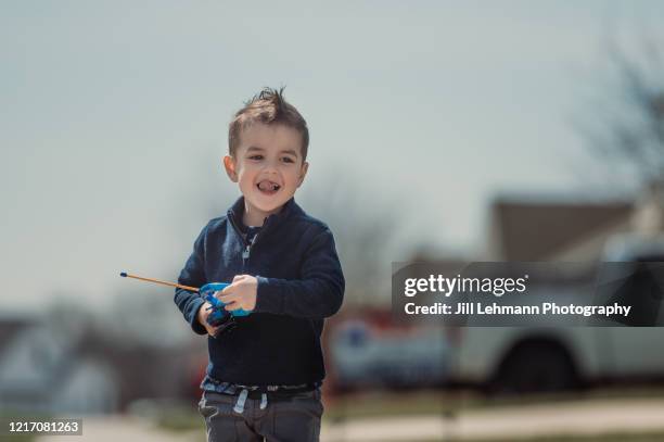 3 1/2 year old toddler plays with toys outside during quarantine alone - remote control car stock pictures, royalty-free photos & images