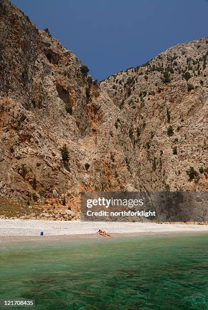 enjoying the sun on a secluded beach - symi stock pictures, royalty-free photos & images