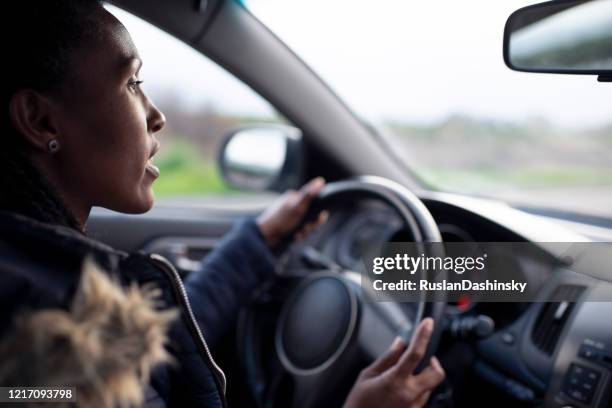 woman driver driving a car. - steering wheel stock pictures, royalty-free photos & images