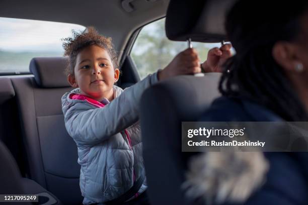 passenger child girl on a car travel journey with mommy. - back seat stock pictures, royalty-free photos & images