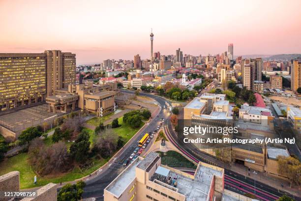 sunset view of johannesburg skyline, hillbrow tower, city council of johannesburg building, gauteng province, south africa - gauteng province stock pictures, royalty-free photos & images