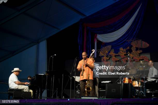 Branford Marsalis performs with his father, Ellis and his brother, Jason , at the New Orleans Jazz and Heritage Festival at the Fair Grounds Race...