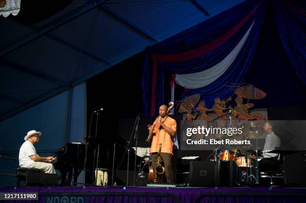 Branford Marsalis performs with his father, Ellis and his brother, Jason , at the New Orleans Jazz and Heritage Festival at the Fair Grounds Race...