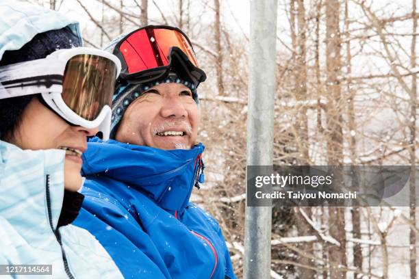 a community of seniors riding the ski lift - woman on ski lift stock pictures, royalty-free photos & images