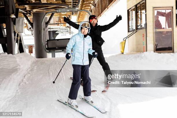 a friendly senior man and woman came down from the ski lift - woman on ski lift stock pictures, royalty-free photos & images