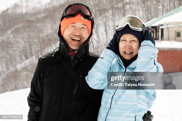 Senior male and female portraits taken on the ski slopes