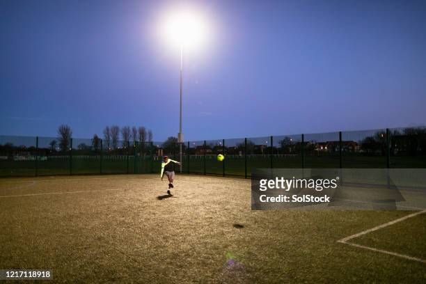 solo striker - floodlit stock pictures, royalty-free photos & images
