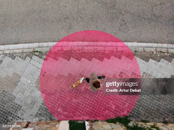 aerial view of social distancing in the street with red circle around person. - social distancing shopping stock pictures, royalty-free photos & images